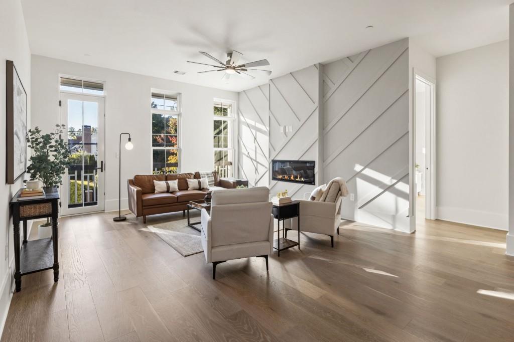 12455 Broadwell Road, Unit 202 Milton, GA 30004 - Photo 16 of 31 a living room with furniture and a wooden floor