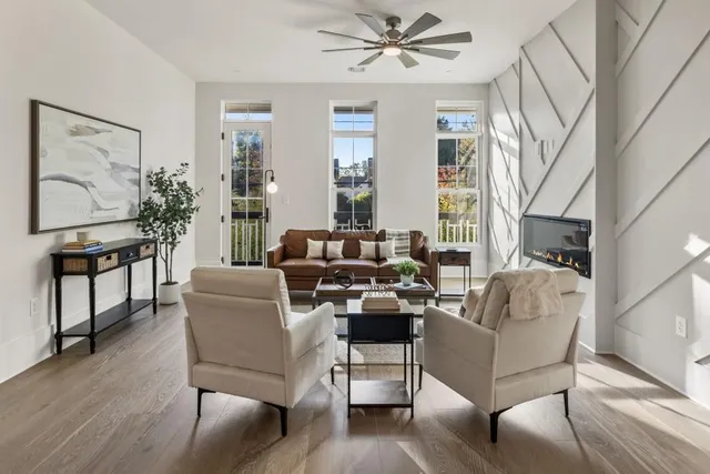 a living room with furniture a fireplace and a chandelier