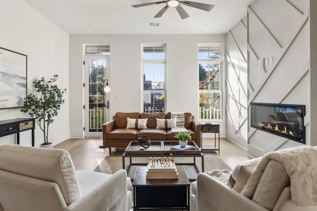 a living room with furniture a ceiling fan and a rug