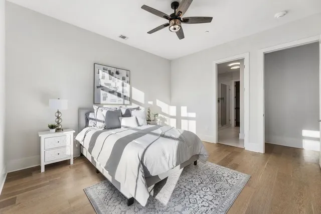 a bed room with a bed and a large window