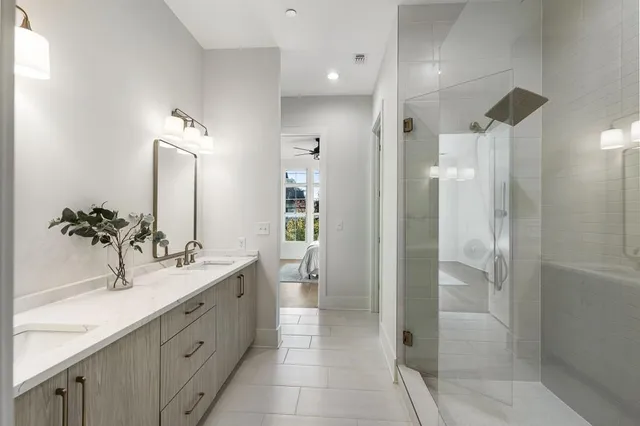 a bathroom with a glass shower door
