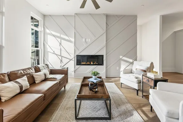 a living room with furniture a rug and a fireplace