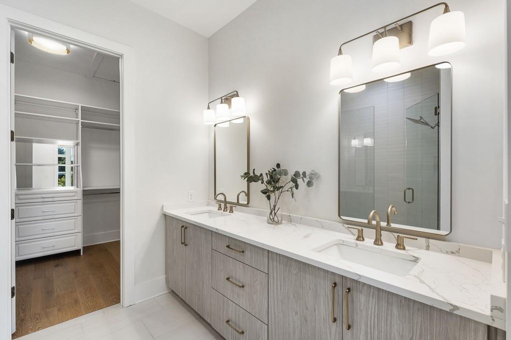 12455 Broadwell Road, Unit 202 Milton, GA 30004 - Photo 5 of 31 a bathroom with a double vanity sink and a mirror