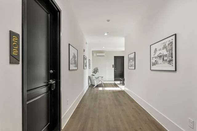a view of a hallway view with wooden floor and staircase