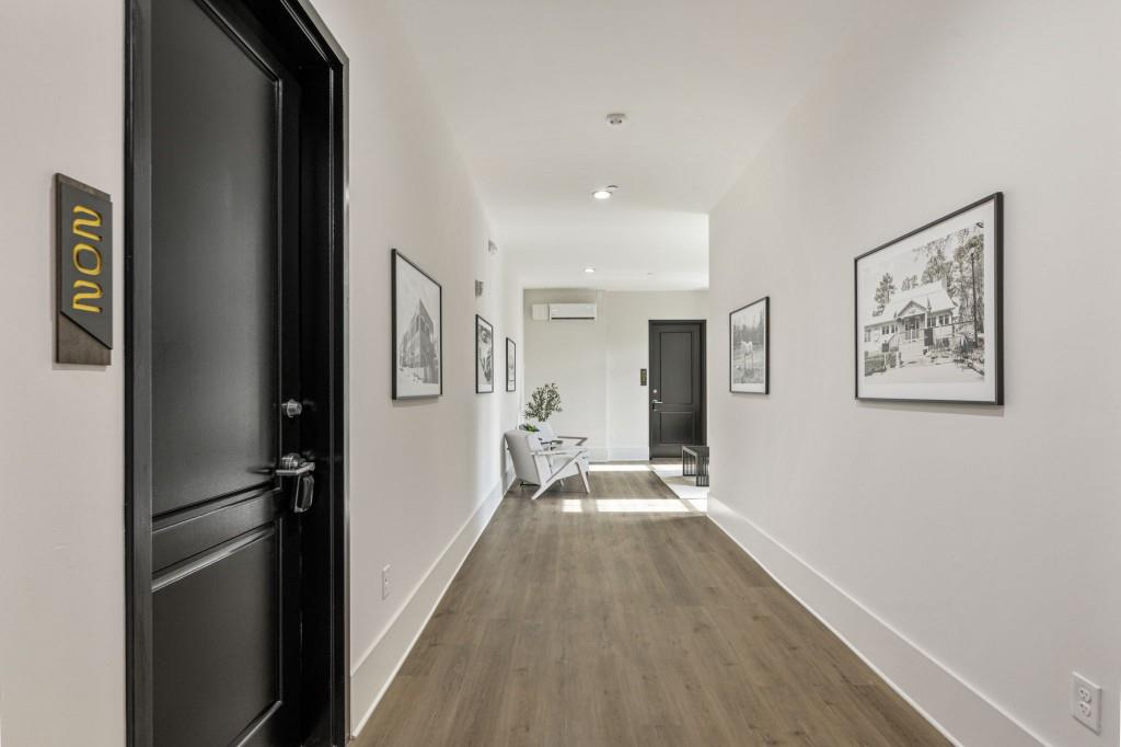 12455 Broadwell Road, Unit 202 Milton, GA 30004 - Photo 7 of 31 a view of a hallway view with wooden floor and staircase