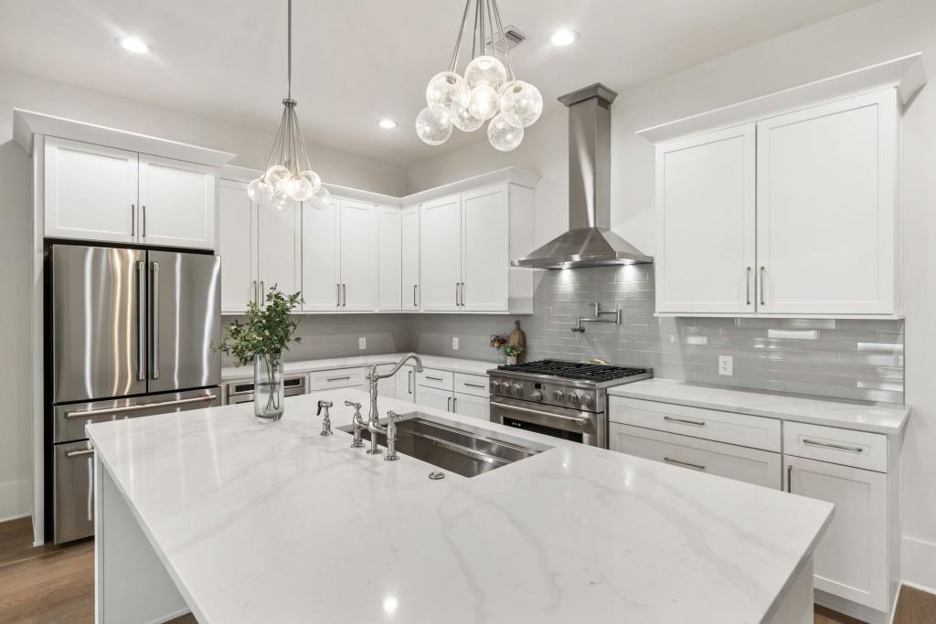 12455 Broadwell Road, Unit 202 Milton, GA 30004 - Photo 8 of 31 a kitchen with stainless steel appliances a stove a sink island and a refrigerator