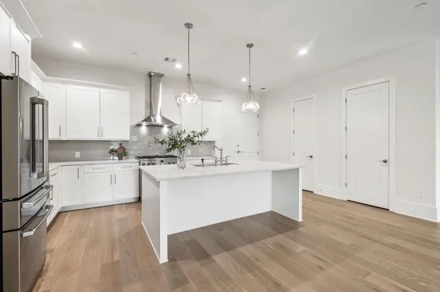 a kitchen with a sink window and stainless steel appliances