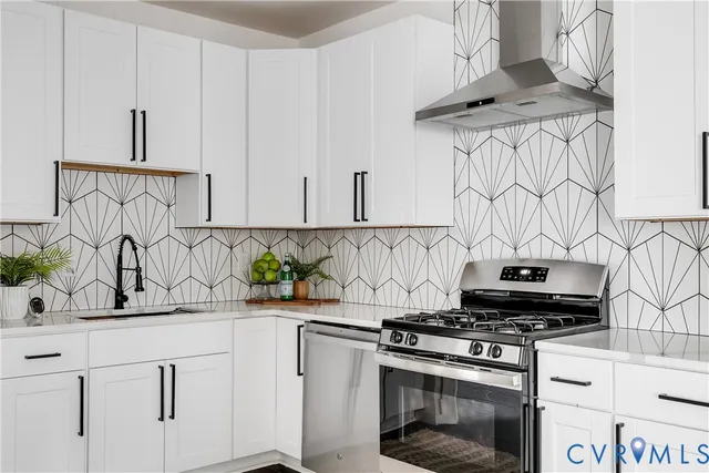 a kitchen with stainless steel appliances a sink a stove and cabinets