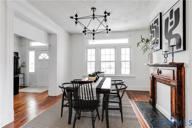 a view of a a dining room with furniture window and wooden floor