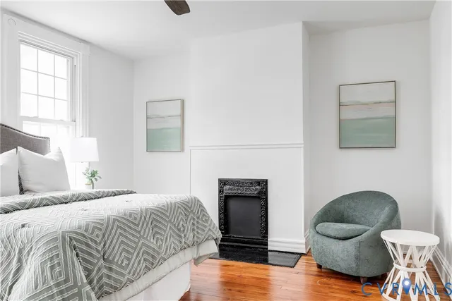 a bathroom with a toilet and a chair