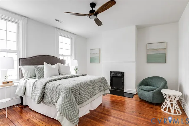 a bedroom with a bed and a potted plant