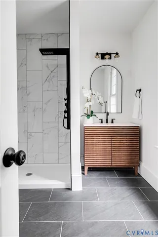 a living room with stainless steel appliances furniture a rug and a window