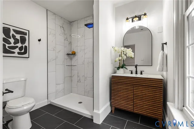 a bathroom with a toilet and a shower