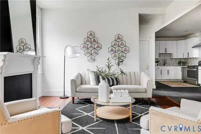 a living room with furniture a flat screen tv and a fireplace