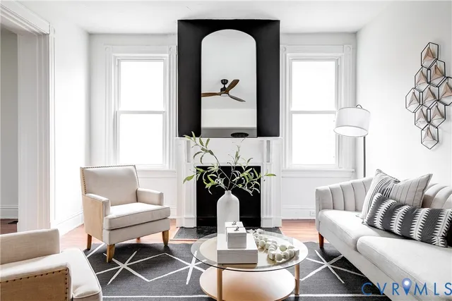 a living room with furniture a fireplace and white walls