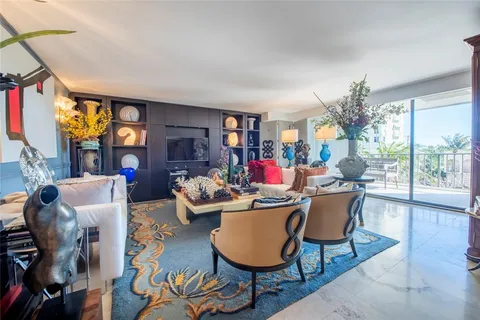 a dining room with furniture a chandelier and a painting