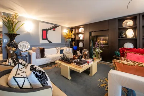 a view of a dining room with furniture and chandelier