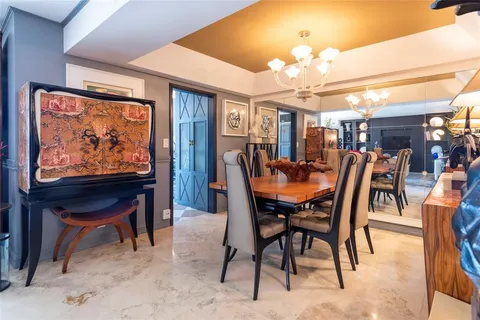 a view of a dining room with furniture and chandelier