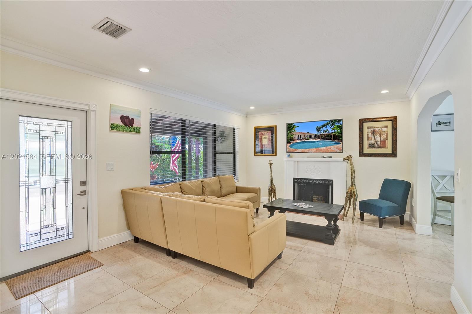 811 Northeast 73rd Street Miami, FL 33138 - Photo 7 of 51 a living room with furniture and a fireplace