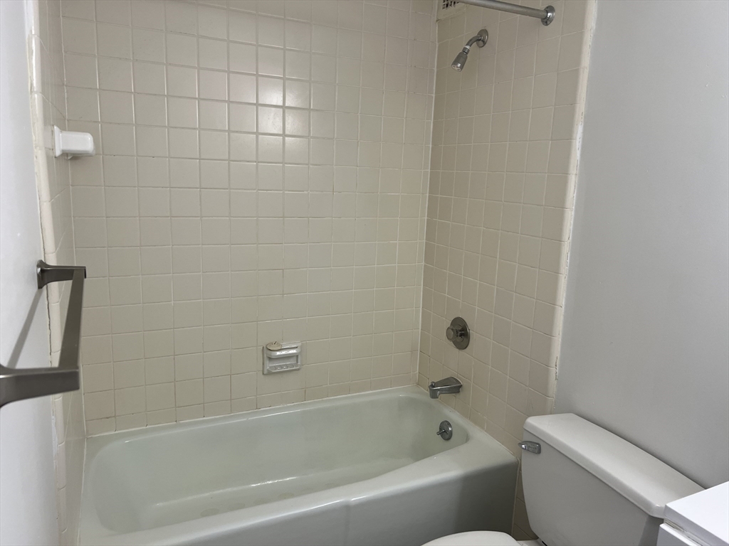 1 Pond Street, Unit 3B Winthrop, MA 02152 - Photo 10 of 11 a bathroom with a bathtub and toilet