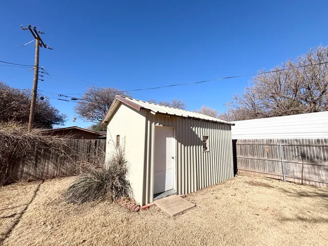 a view of a house with a wooden fence