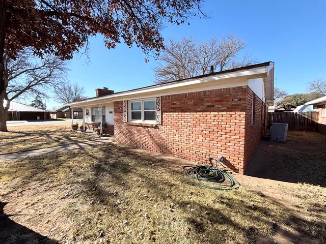a view of a house with a yard covered in snow