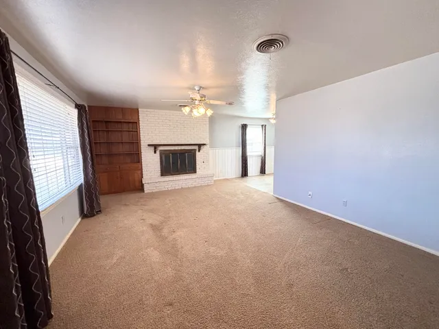 a view of empty room with a fireplace