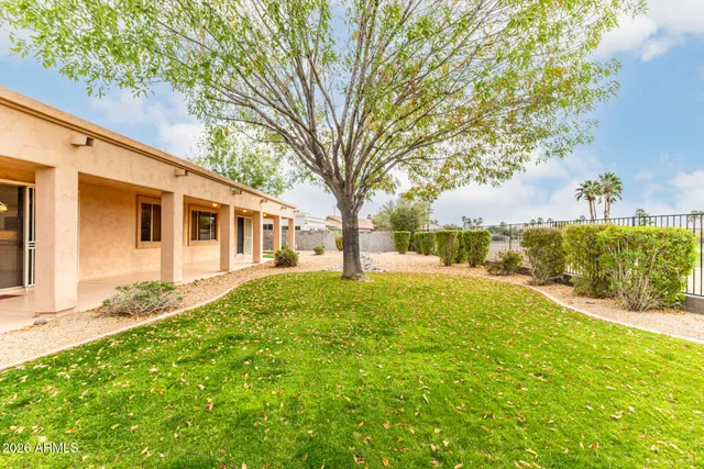 a large kitchen with granite countertop a large counter top stainless steel appliances and cabinets