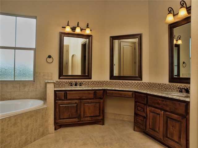 104 Vista Lane Georgetown, TX 78633 - Photo 14 of 36 The master bath features a corner soaking tub with double sinks.