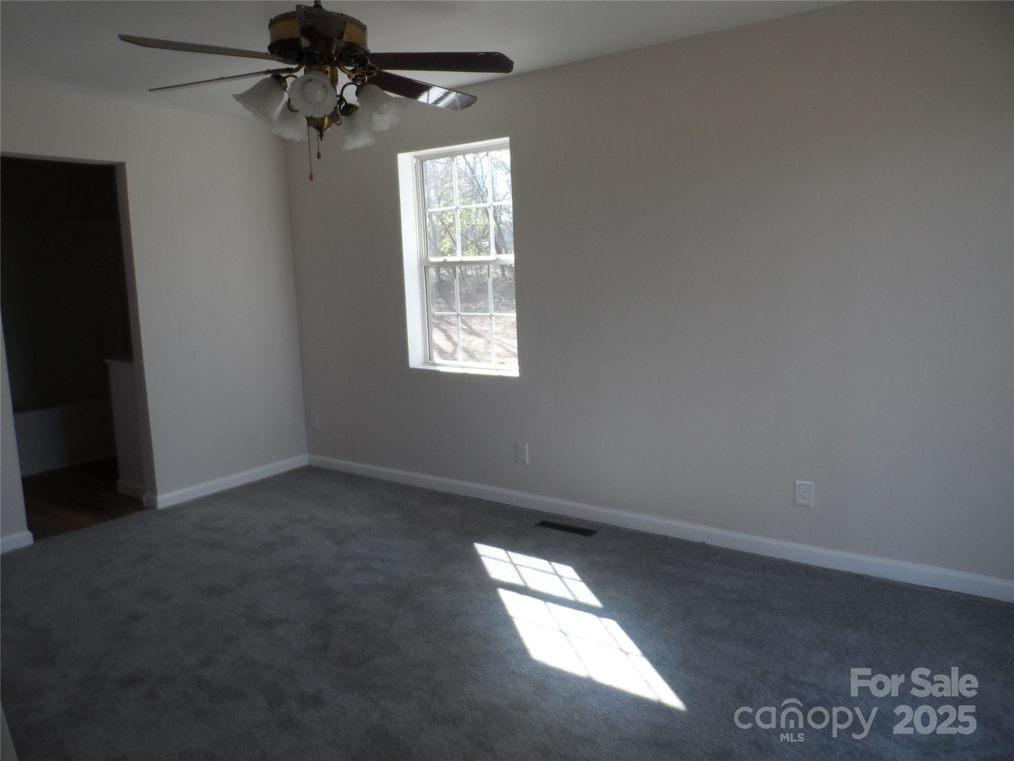 205 Phillips Street Morganton, NC 28655 - Photo 11 of 22 an empty room with a window and a fan