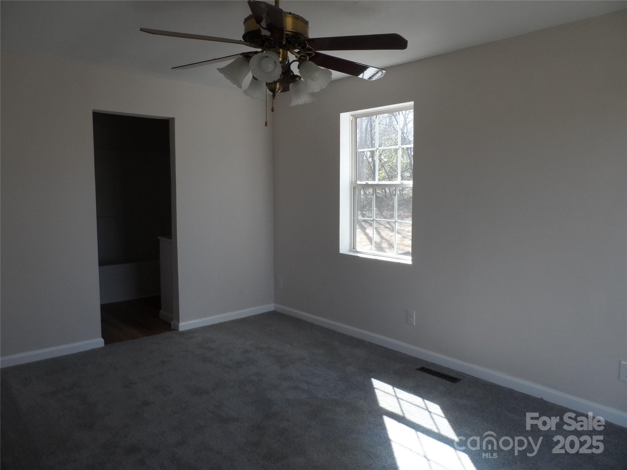205 Phillips Street Morganton, NC 28655 - Photo 12 of 22 an empty room with windows and fan