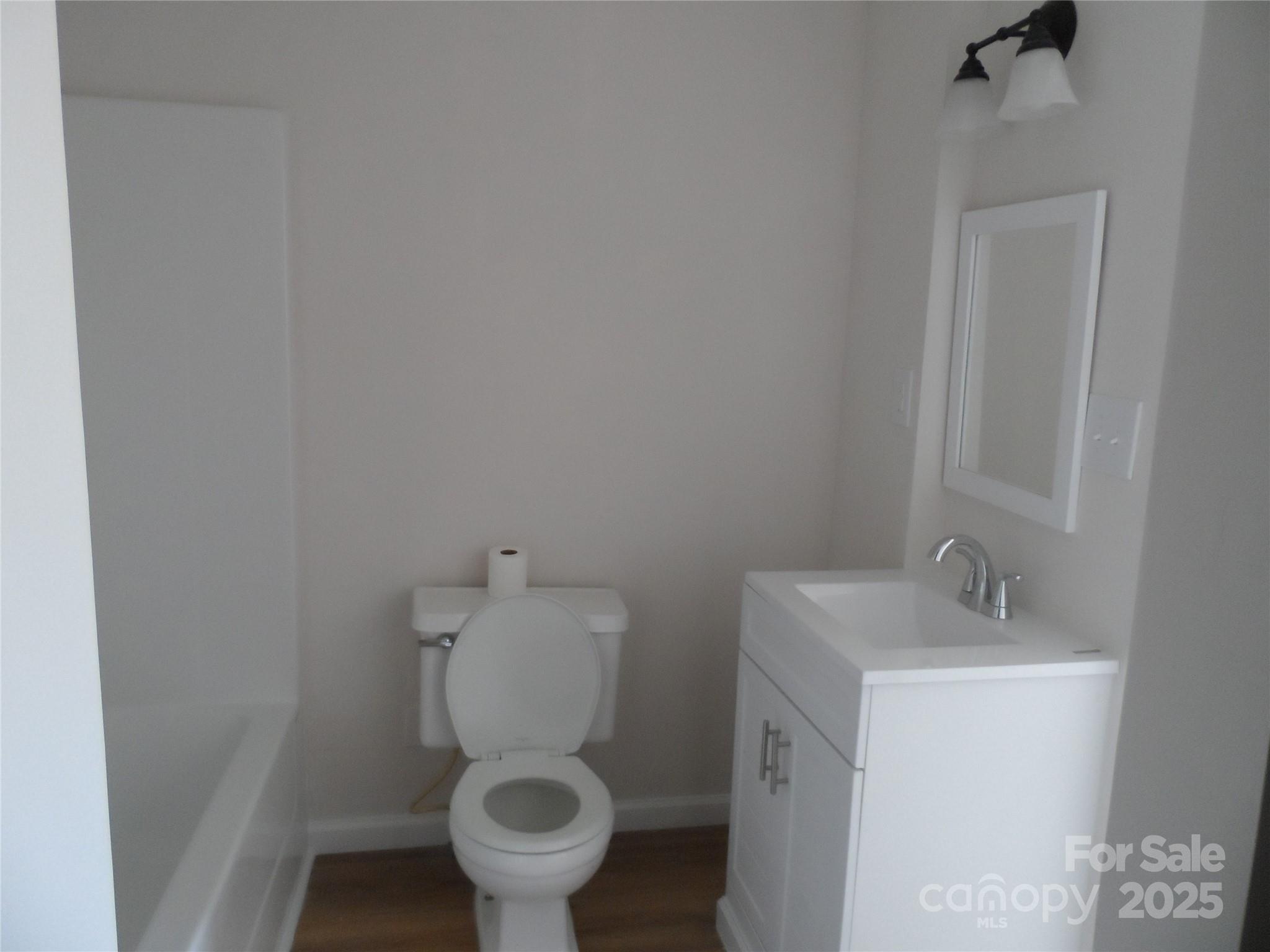 205 Phillips Street Morganton, NC 28655 - Photo 14 of 22 a white toilet sitting next to a bathroom sink