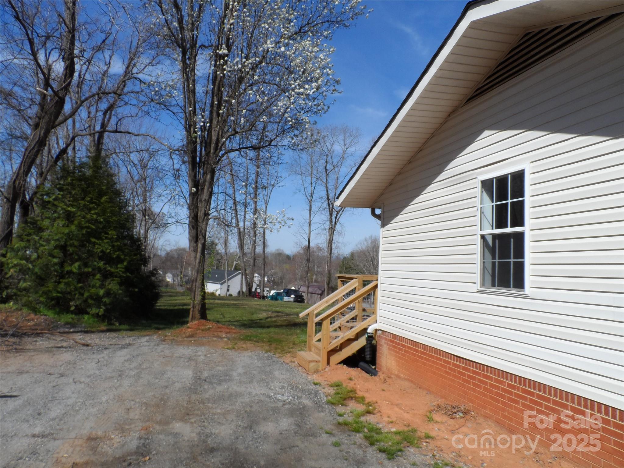 205 Phillips Street Morganton, NC 28655 - Photo 20 of 22 a backyard of a house with wooden fence and large trees