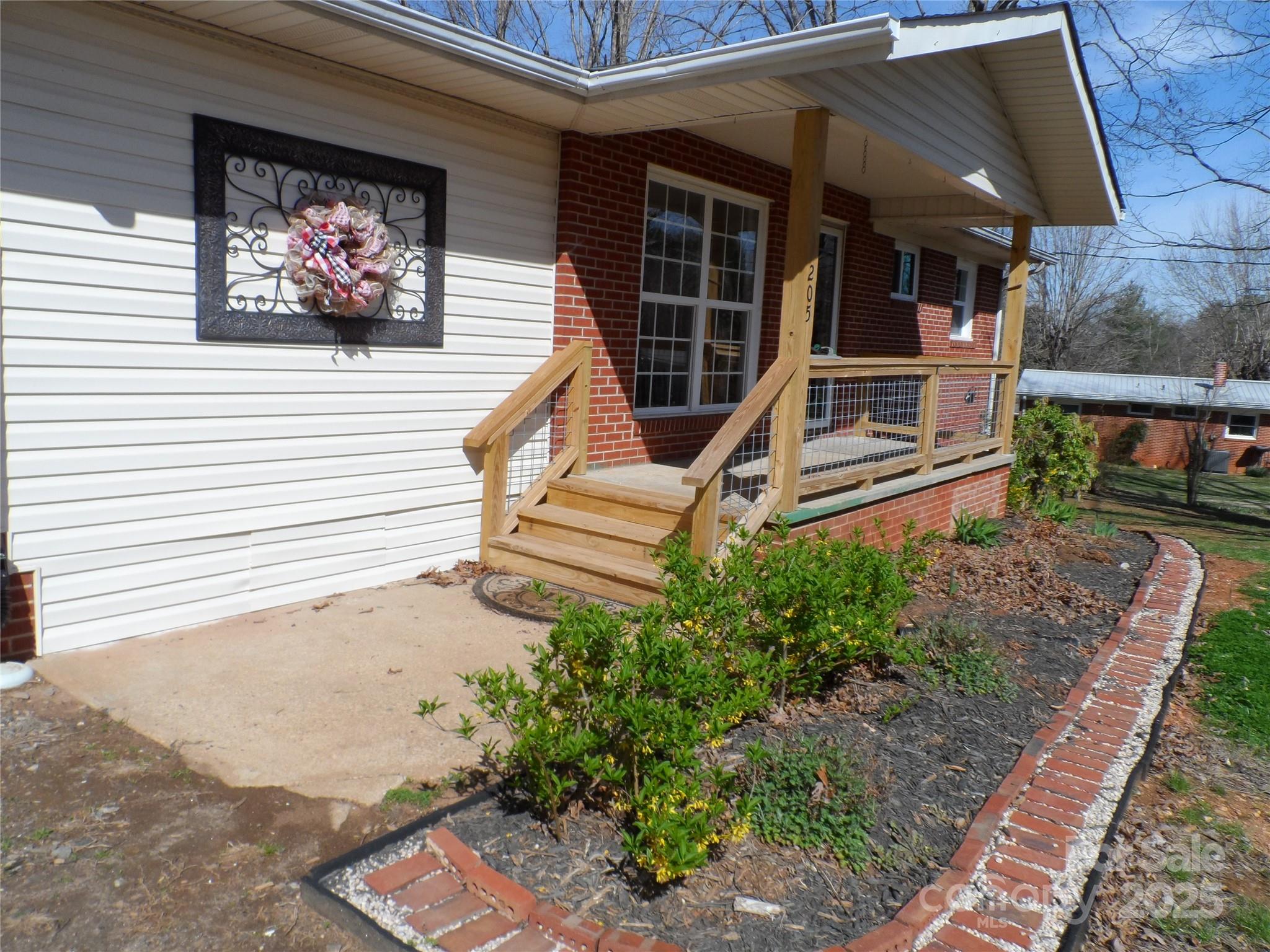 205 Phillips Street Morganton, NC 28655 - Photo 2 of 22 a view of a house with a small yard and wooden floor and fence