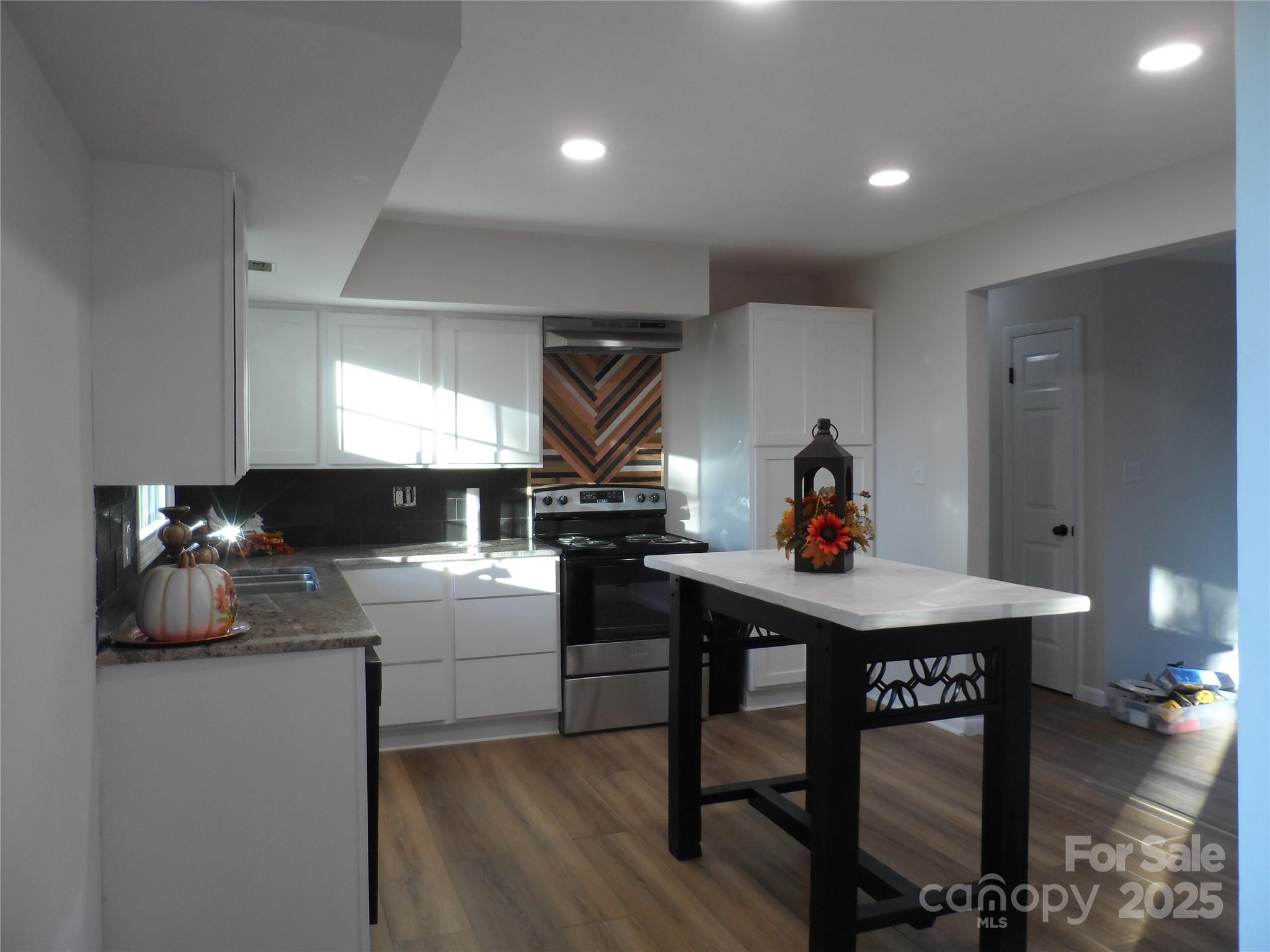 205 Phillips Street Morganton, NC 28655 - Photo 6 of 22 a kitchen with a sink cabinets and wooden floor