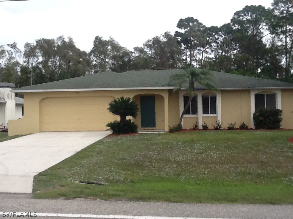 17217 Oriole Road Fort Myers, FL 33967 - Photo 1 of 22 a view of a backyard with plants and large tree