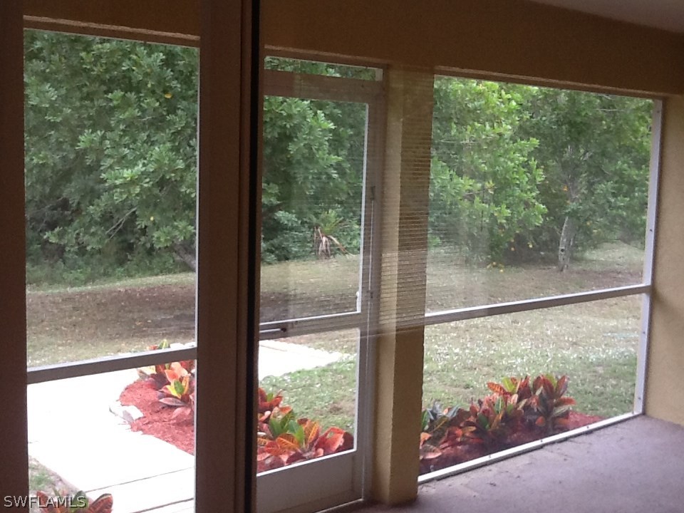 17217 Oriole Road Fort Myers, FL 33967 - Photo 18 of 22 a view of a glass door with a tree outside