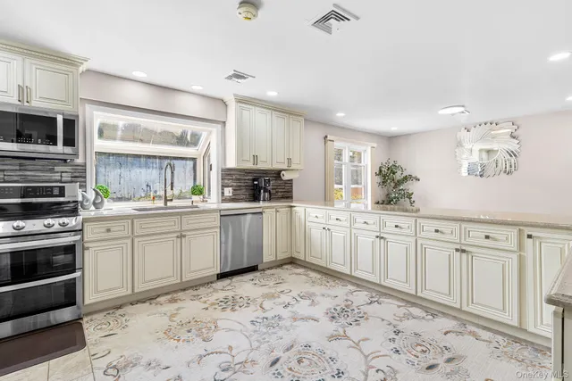 a kitchen with granite countertop white cabinets and white appliances
