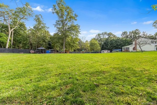 a view of a swimming pool and trees in the background