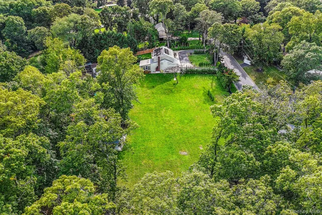 a backyard of a house with a yard and outdoor seating