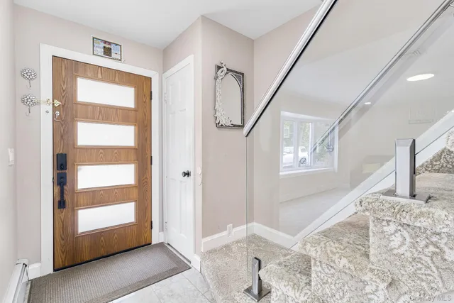 a view of a hallway with windows and entryway