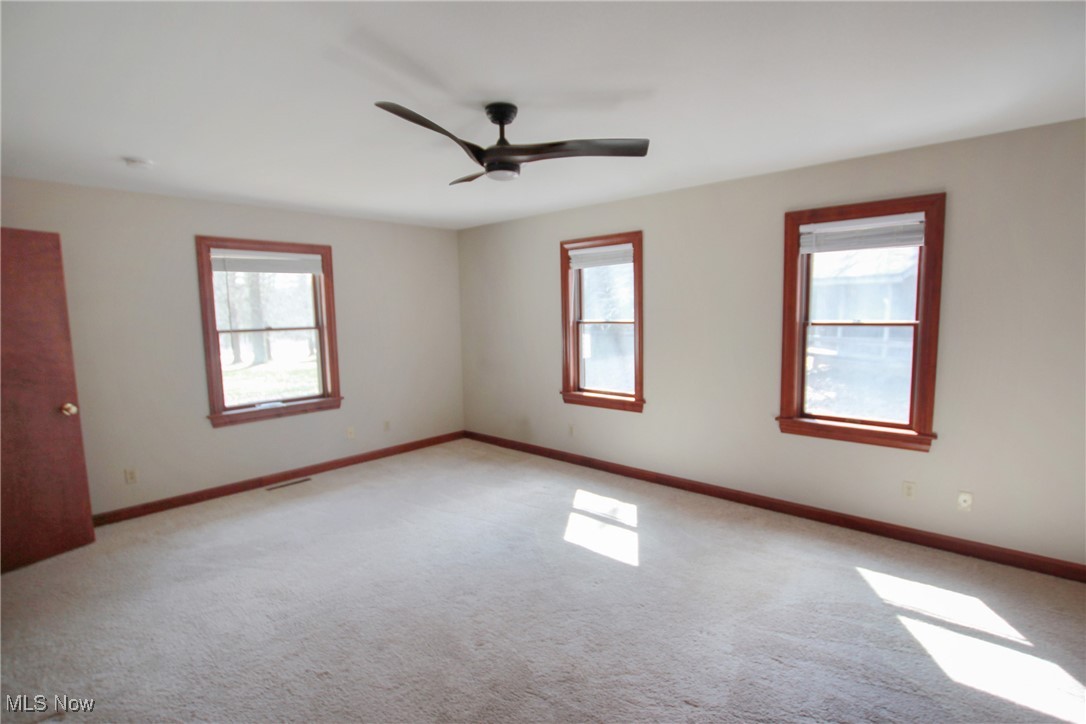 1031 Georgetown Road Salem, OH 44460 - Photo 15 of 31 Empty room with a ceiling fan, visible vents, light colored carpet, and baseboards