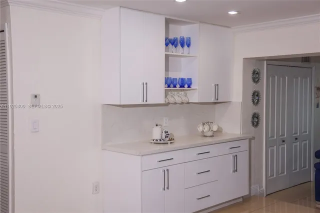 a kitchen with cabinets and window