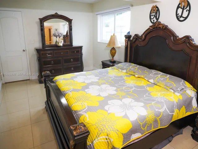 a bed sitting in a bedroom with a dresser