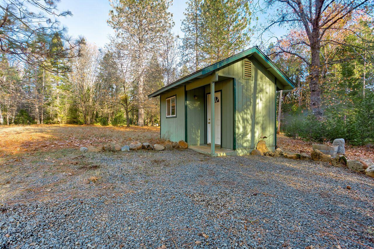 30057 Rl Smith Logging Road Oak Run, CA 96069 - Photo 50 of 58 a view of a house with large trees and covered area