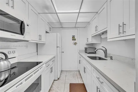 a kitchen with stainless steel appliances a sink stove and cabinets