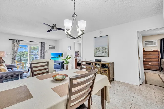 a view of a dining room and hall with furniture