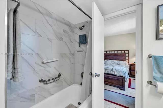 a bathroom with a tub and shower