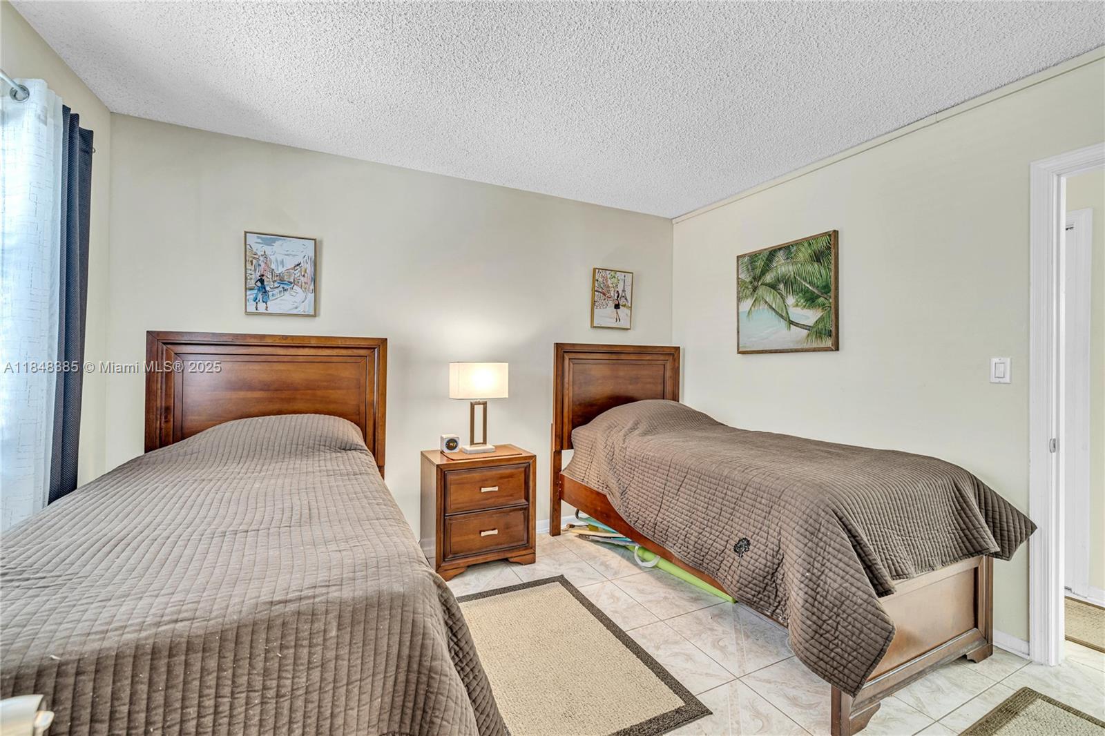 200 South Birch Road, Unit 201 Fort Lauderdale, FL 33316 - Photo 22 of 28 a bedroom with a large bed and a couch