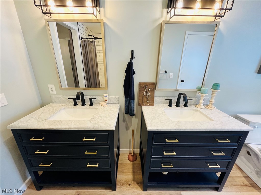 13655 Spring Street Burton, OH 44021 - Photo 5 of 48 Bathroom with vanity, toilet, and wood-type flooring